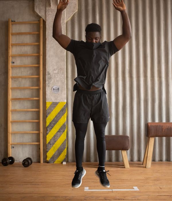 Woman feeling energized during a light cardio workout in a modern studio.